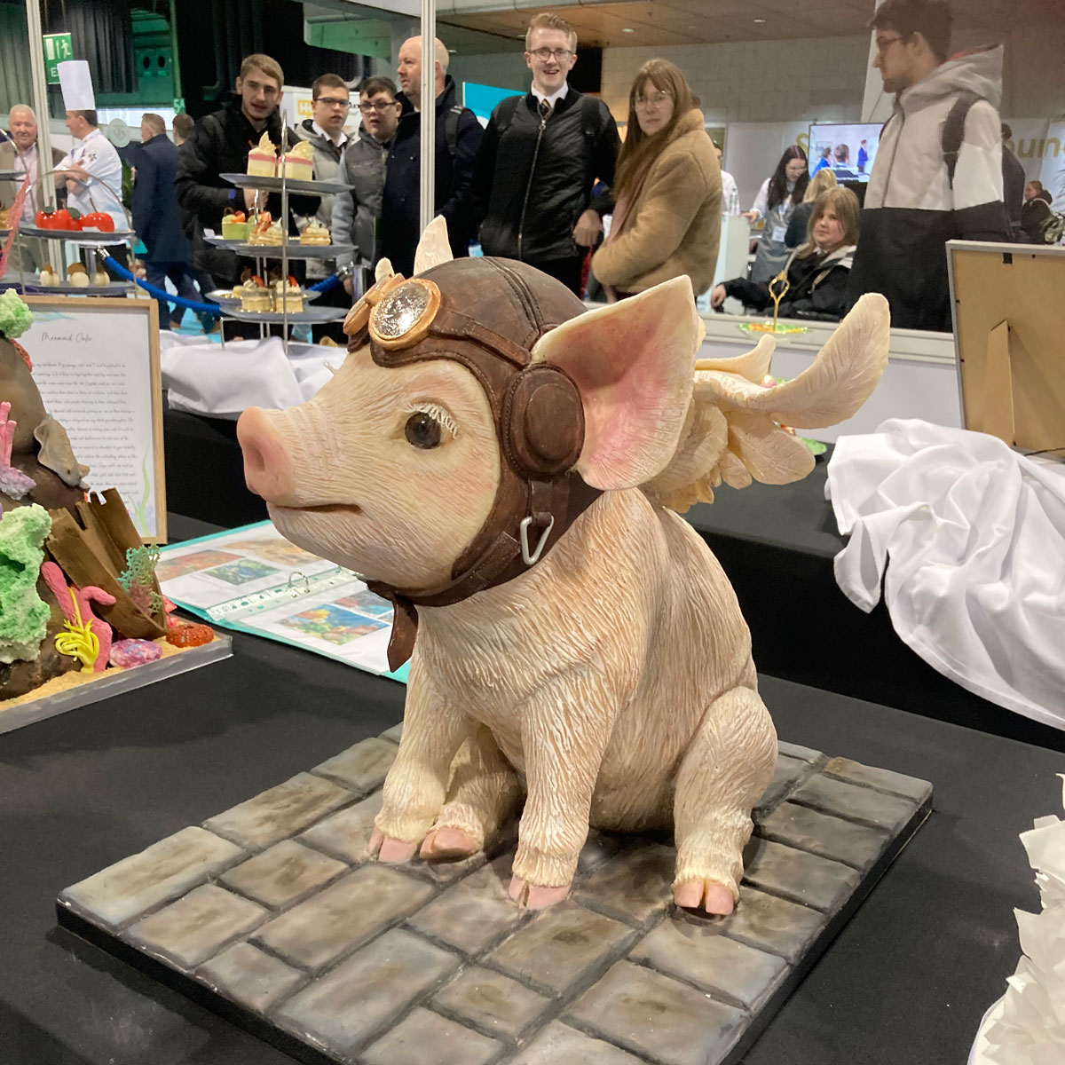 An elaborately iced cake in the shape of a piglet