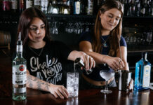 Bacardi’s budding barstaff begin building-up before Bartenders Ball baptism! Two young women serve behind a bar