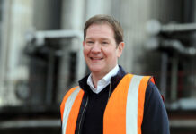 A ‘great leader and passionate ambassador’ takes the helm at Molson Coors a smiling man wear hi-vis against an industrial background