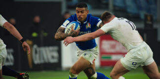 Two grown men fight over an egg-shaped ball