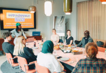 A team of colleagues meet in a freshly decorated conference room