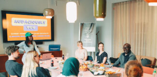 A team of colleagues meet in a freshly decorated conference room