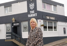 Belhaven Pub Partners opens The Tarbet as its first Scottish franchise pub A woman stands outside a black-and white painted pub