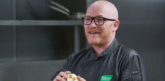 A bearded man demonstrates cookery