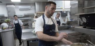 Smartly dressed kitchen staff at work in a modern kitchen