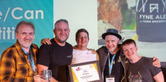 A group of casually dressed men receive an award