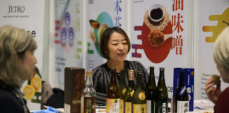 An exhibitor at ScotHot speaks to visitors.
