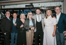 A group of well-dressed older people at an awards ceremony