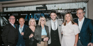 A group of well-dressed older people at an awards ceremony