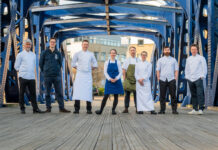 a group of chefs on a bridge