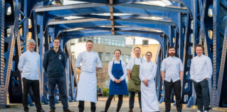 a group of chefs on a bridge