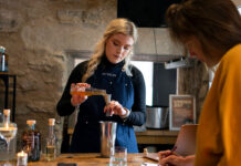 A female bartender prepares. a competitive cocktail