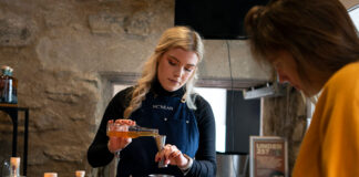 A female bartender prepares. a competitive cocktail