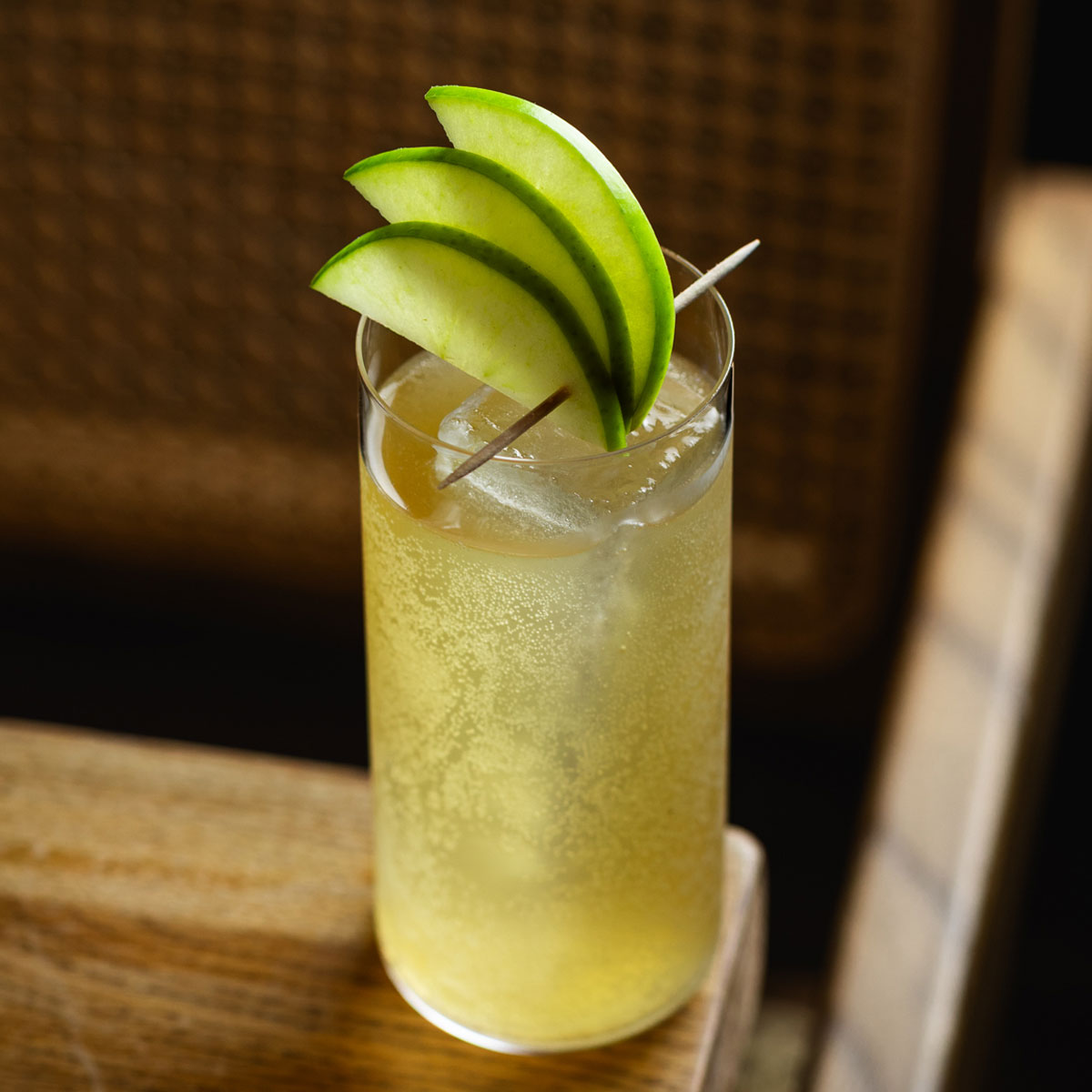A fruity-looking cocktail in a tall glass