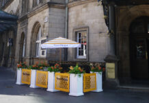 An outdoor pop-up bar on a corner next to train station