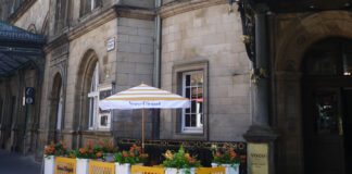 An outdoor pop-up bar on a corner next to train station