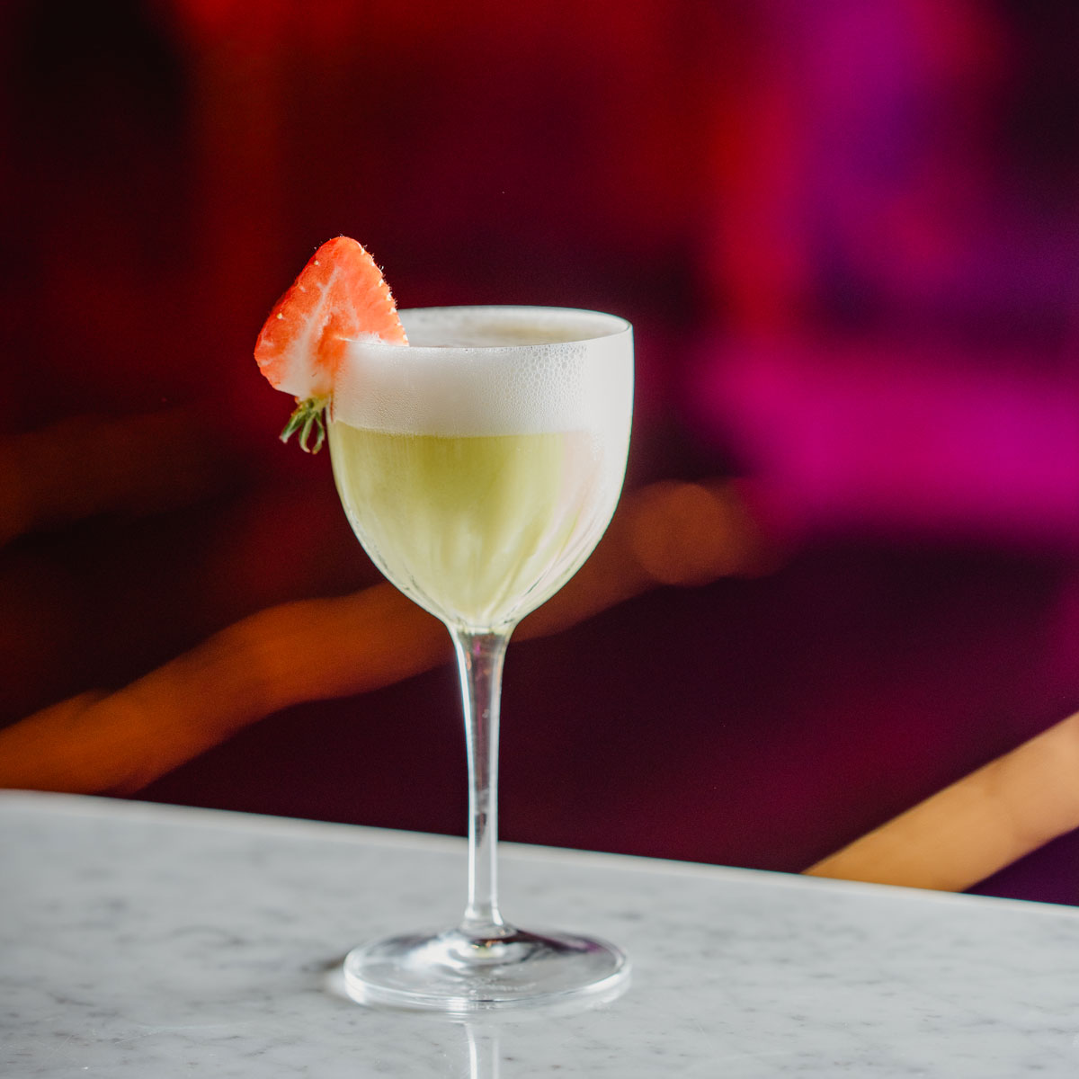 a green foamy cocktail