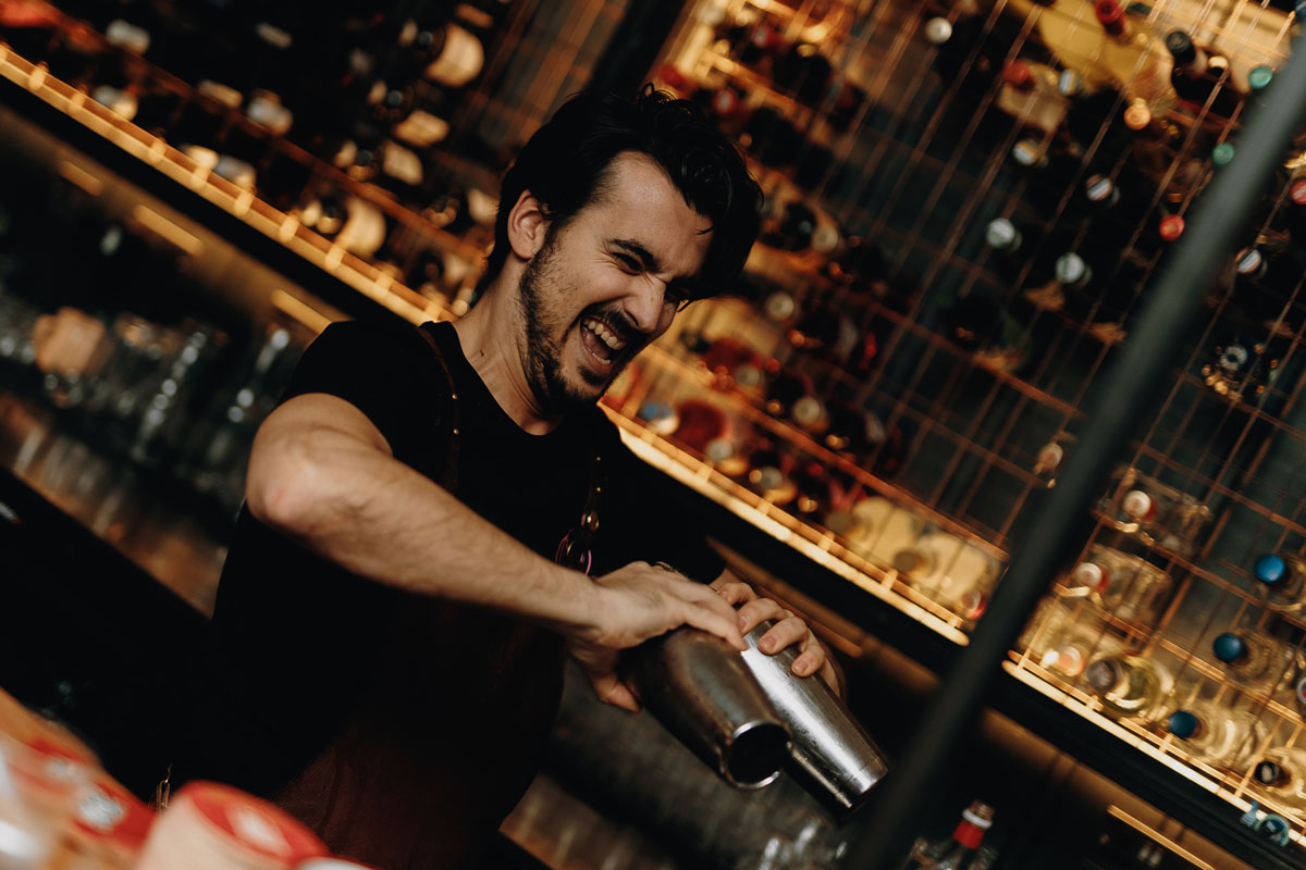 A bartender shakes a cocktail
