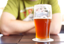 Mixed Easter trading as National Insurance changes take effect A half full pint glass sits on a table in front of a man with crossed arms