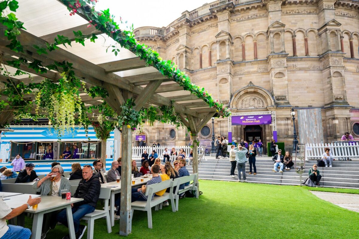 People drinking outside and enjoying Underbelly festival at Bristo Square, Edinburgh