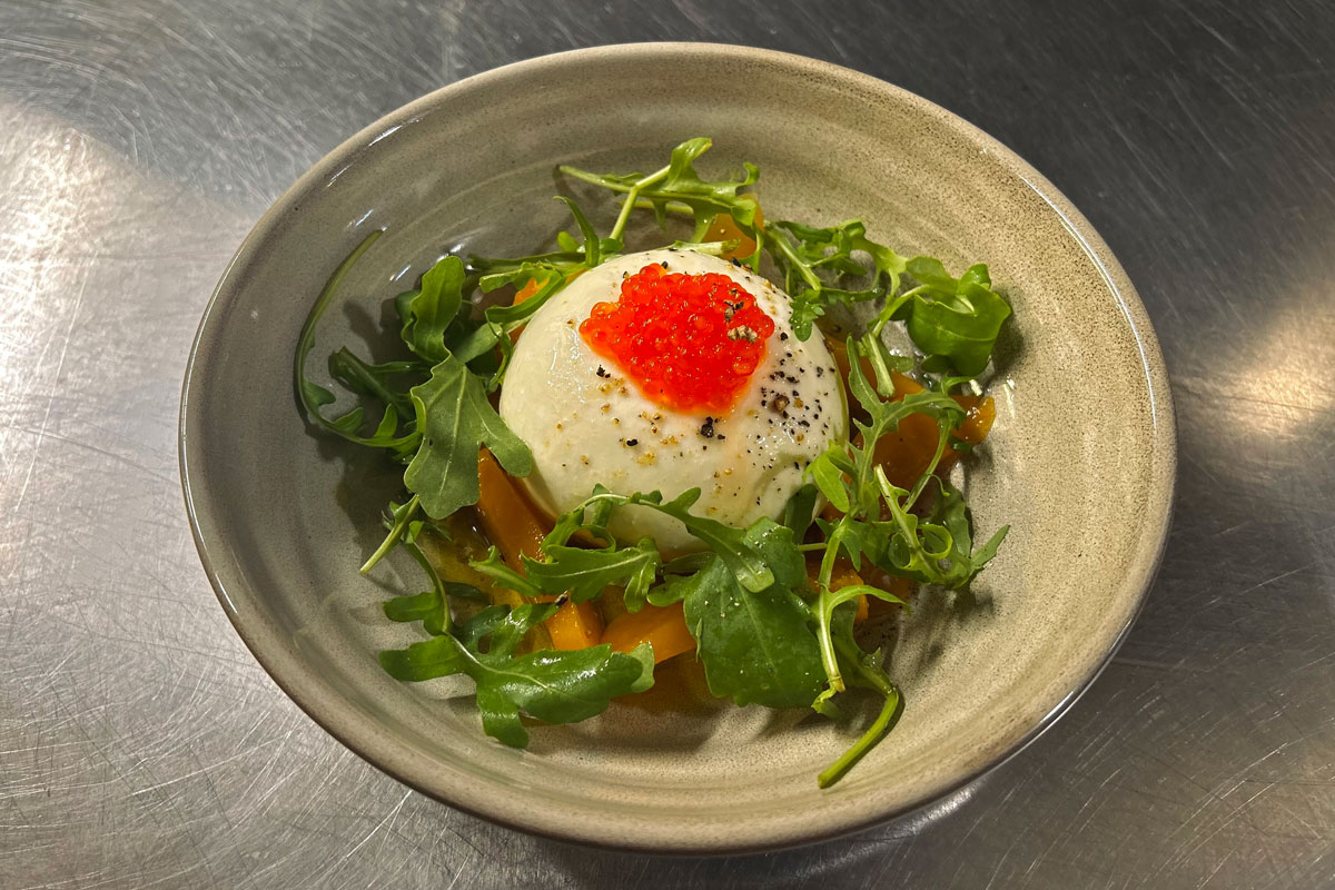 A well dressed dish of burrata