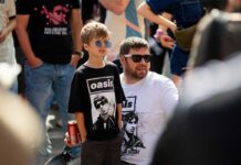 A father and son attending an Oasis concert.