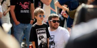 A father and son attending an Oasis concert.